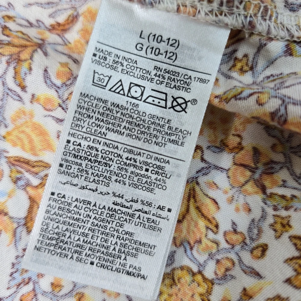 Old Navy girls' sleeveless summer sundress in orange, yellow, and white